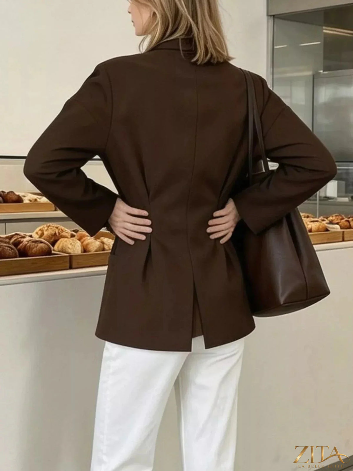Zita La Belle Elite pleated waist blouse with button detail, showcasing a flowy fabric and elegant design in a close-up view.
