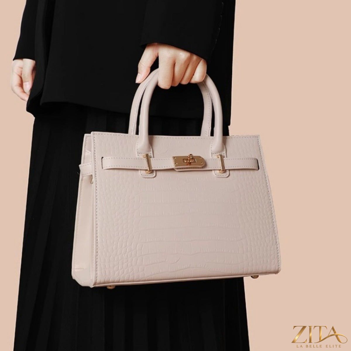 Crocodile-embossed leather top handle handbag by Zita La Belle Elite with gold hardware and structured design.