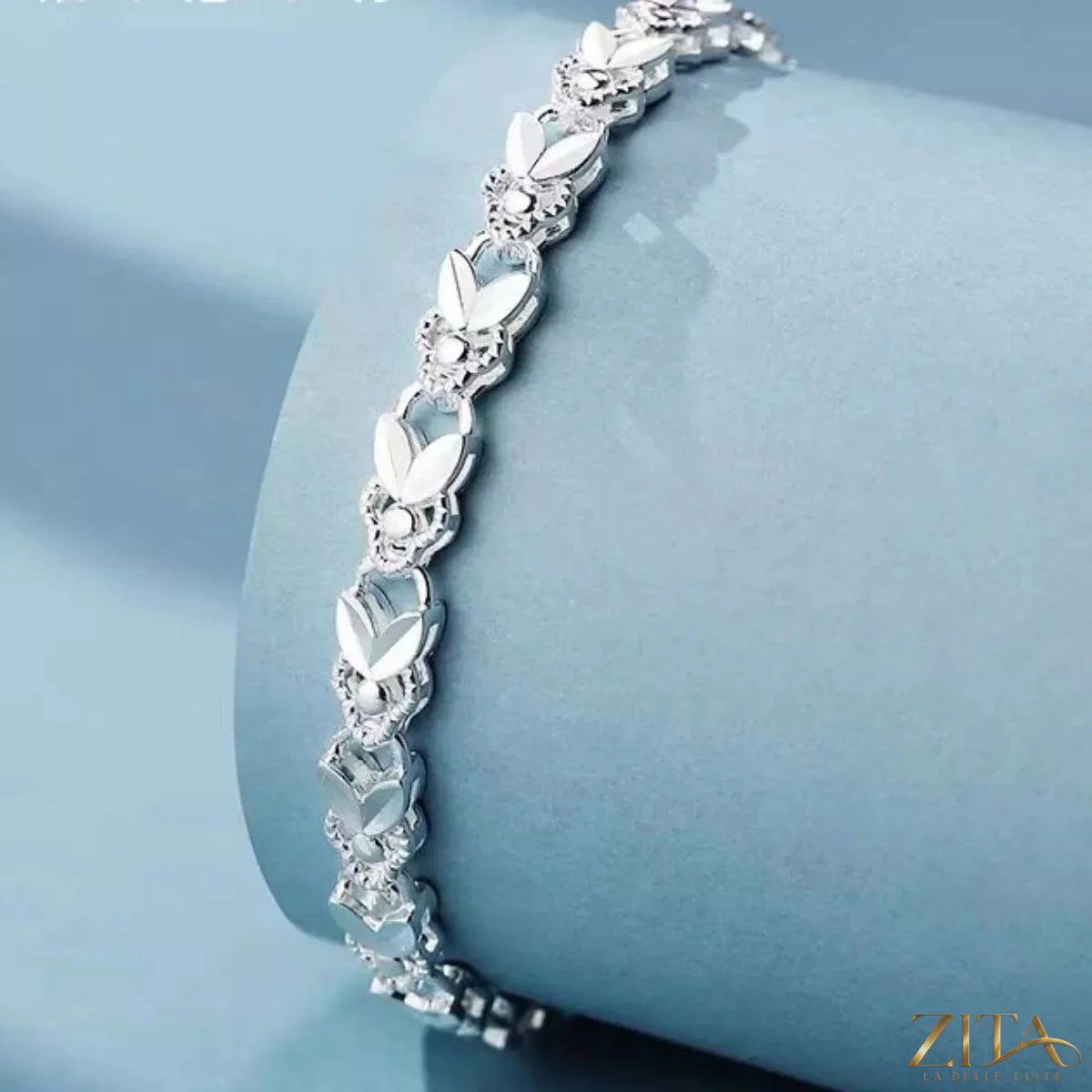 Sterling silver chain bracelet with delicate link design, crafted in 925 silver, shown on a neutral background.