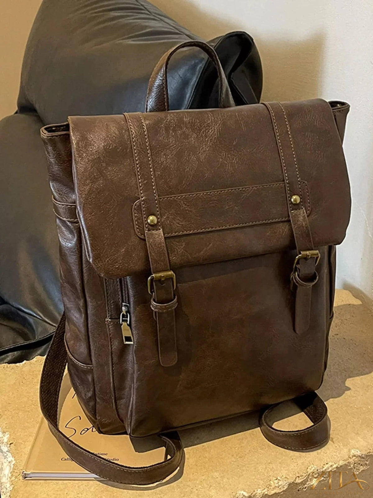 Leather flap backpack bag by Trendsi featuring a sleek design, adjustable straps, and spacious main compartment.
