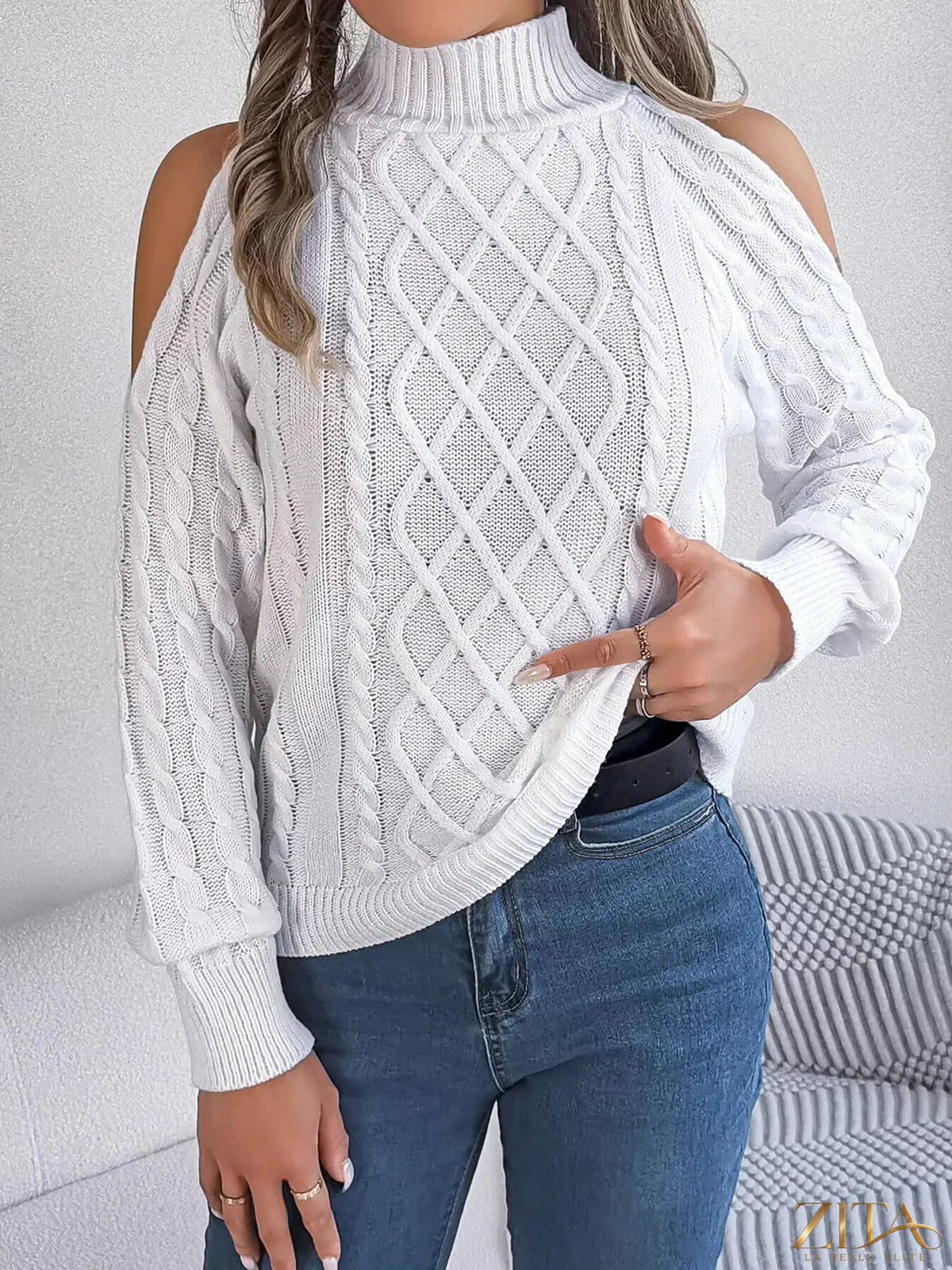 Zita La Belle Elite cold-shoulder cable knit sweater in cozy cream with stylish cut-out shoulders and textured knit pattern.