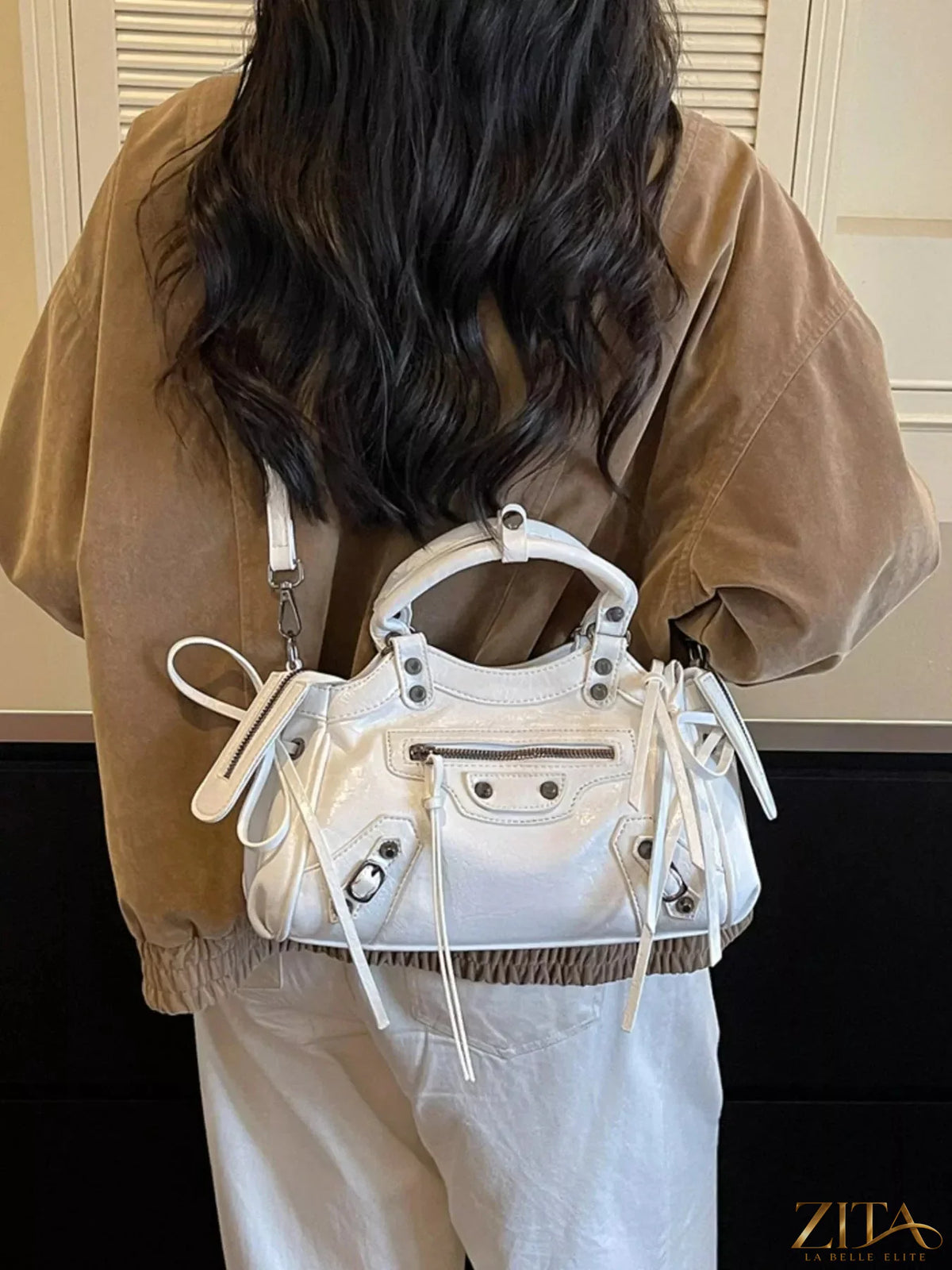 Leather tassel handbag by Trendsi featuring a sleek design, with leather tassels and a spacious interior for everyday use.