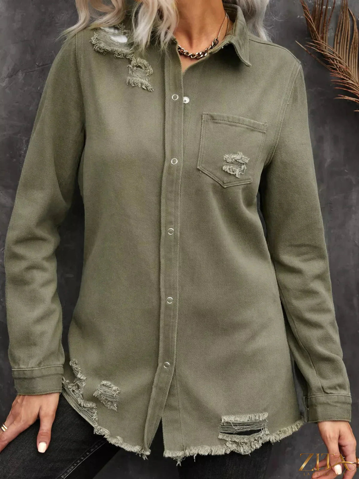 Zita La Belle Elite raw hem distressed denim shirt jacket with frayed edges and casual fit, displayed on a hanger.
