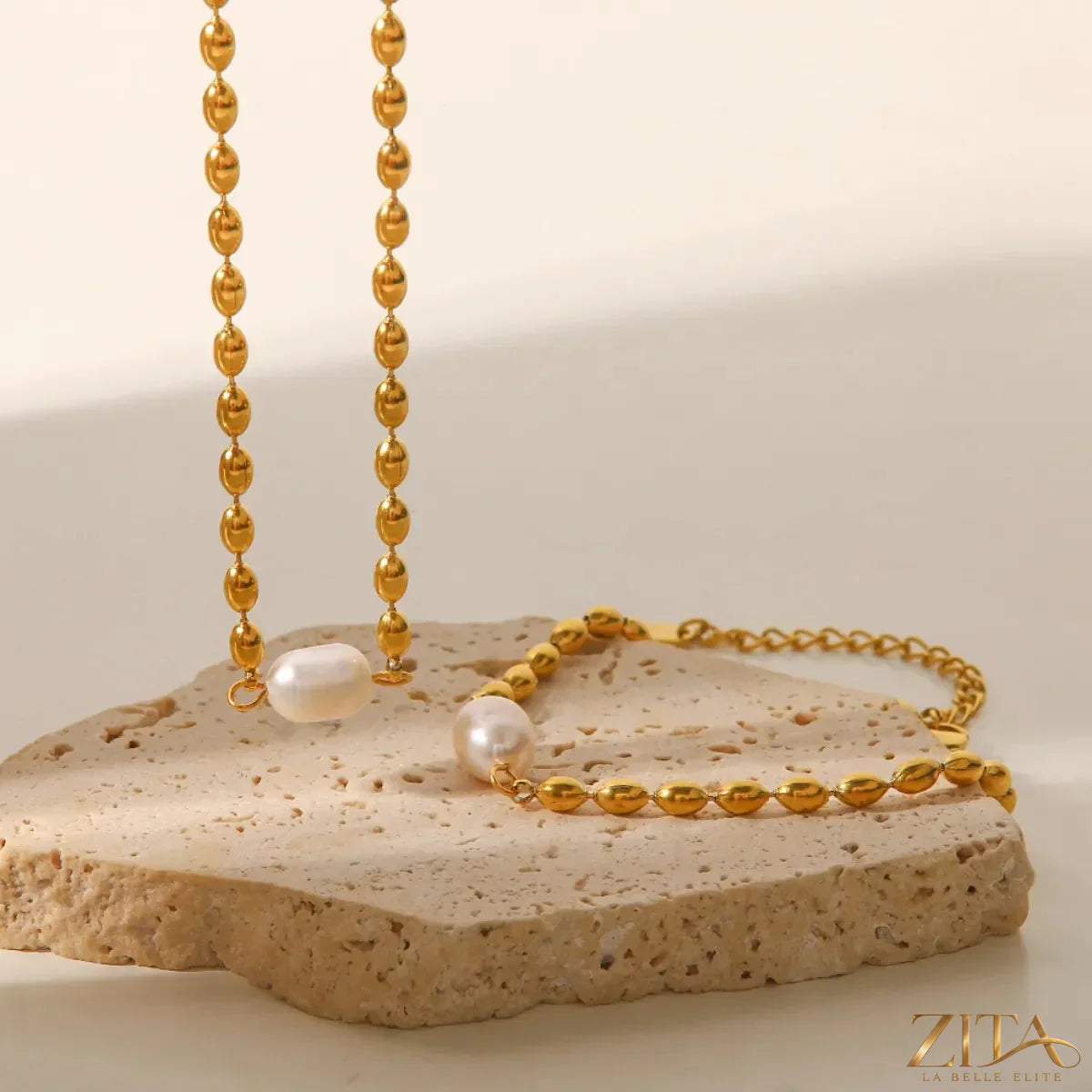 Pearl and gold chain jewelry set featuring a necklace and bracelet with elegant pearls and gold accents.