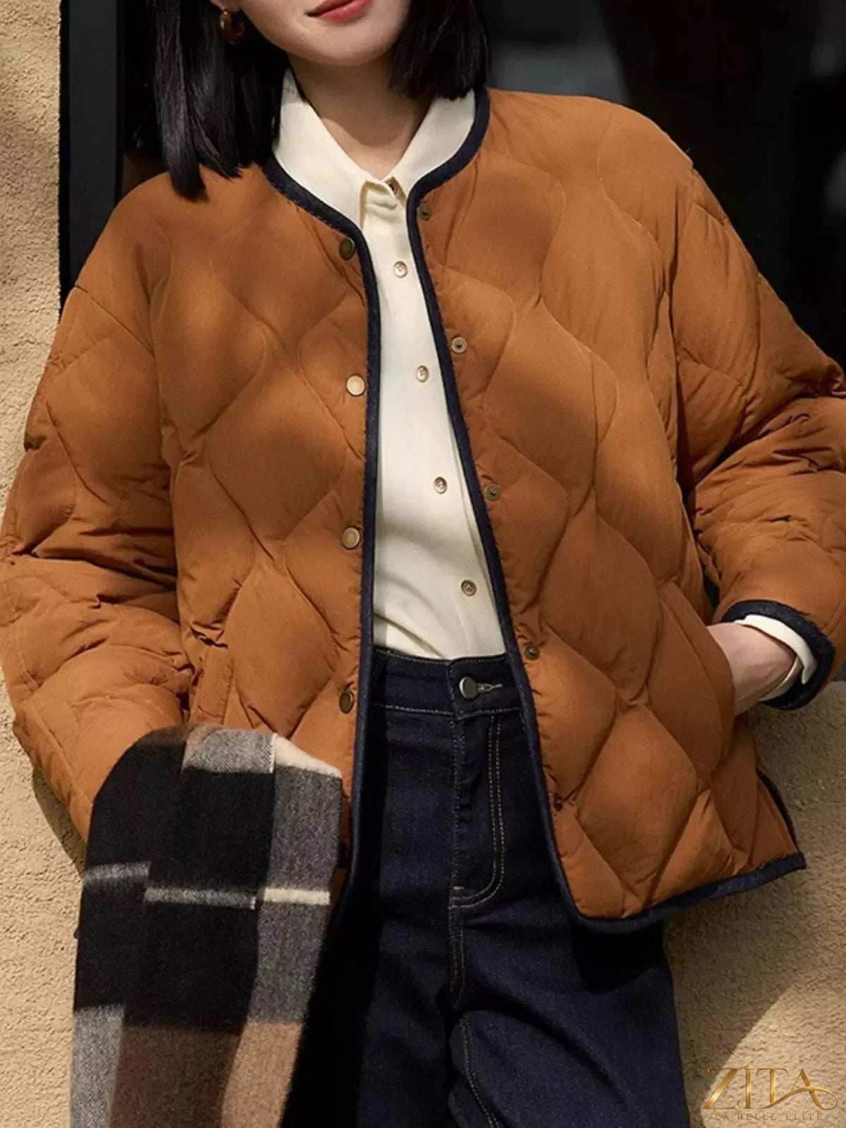 Diamond-quilted lightweight reversible down jacket by Zita La Belle Elite, showing its cropped fit and stylish quilted design.