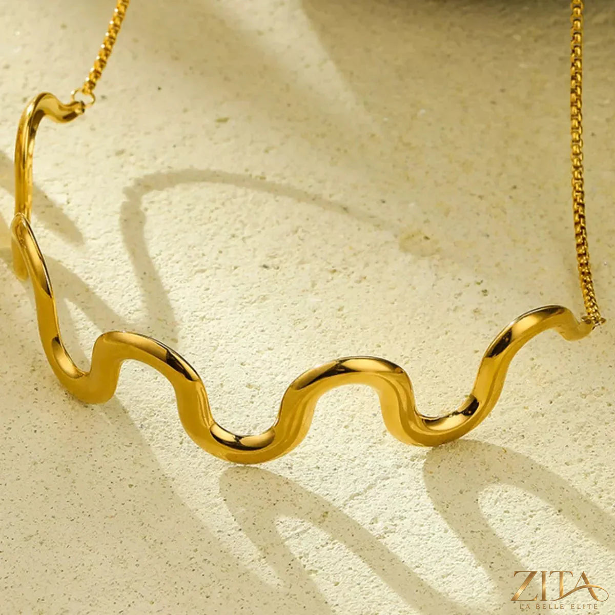 18K gold-plated wave necklace by Zita La Belle Elite, featuring a flowing, elegant design with shiny gold finish.