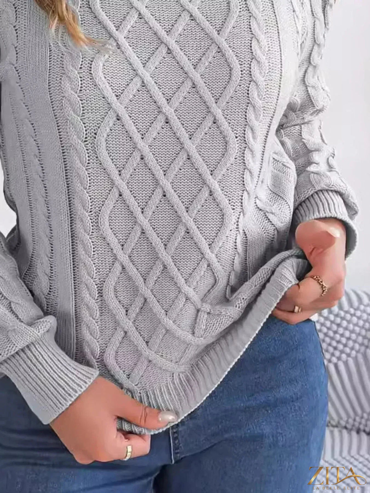 Zita La Belle Elite cold-shoulder cable knit sweater in soft fabric with ribbed cuffs and stylish cut-out shoulder details.