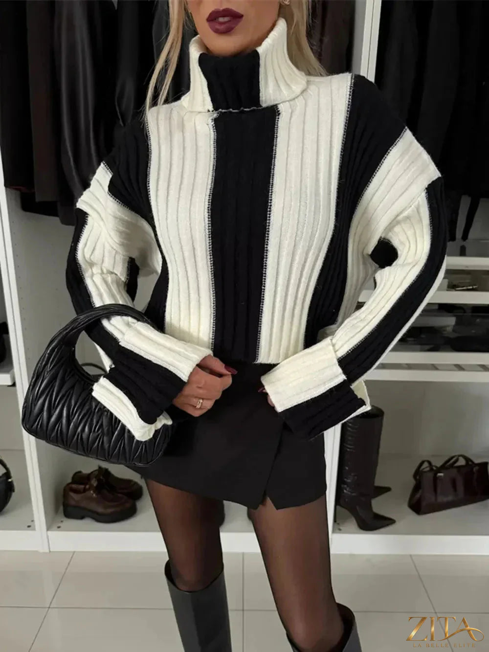 Striped turtleneck sweater with dropped shoulders by Trendsi, featuring a cozy fit and stylish horizontal stripe pattern.