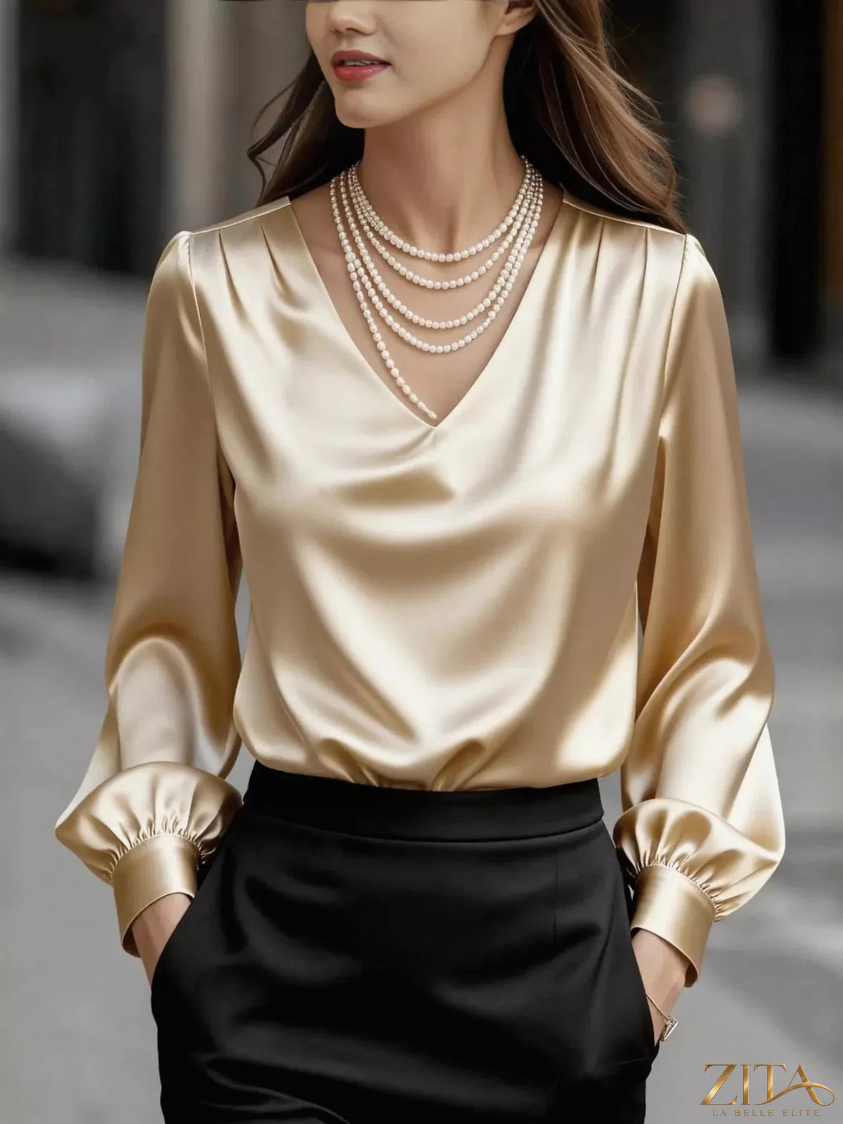 Zita La Belle Elite satin V-neck long sleeve blouse with elegant drape, displayed on a mannequin in a soft neutral setting.