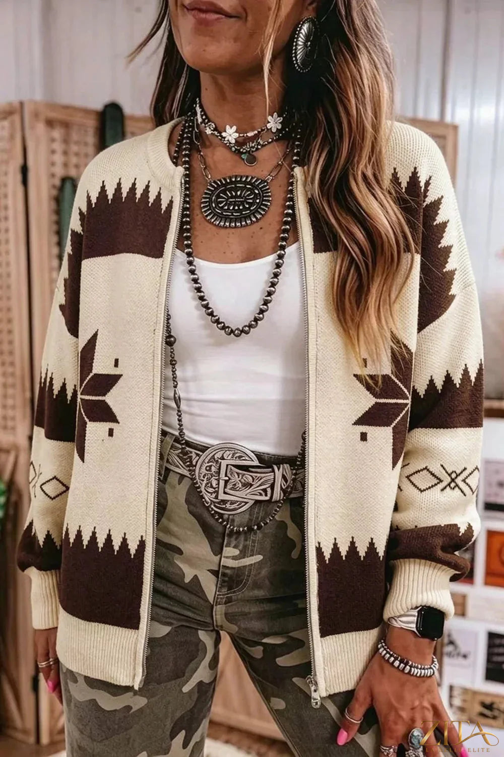 Zita La Belle Elite geometric zip-up knit cardigan with bold pattern, long sleeves, and front zipper on a model.