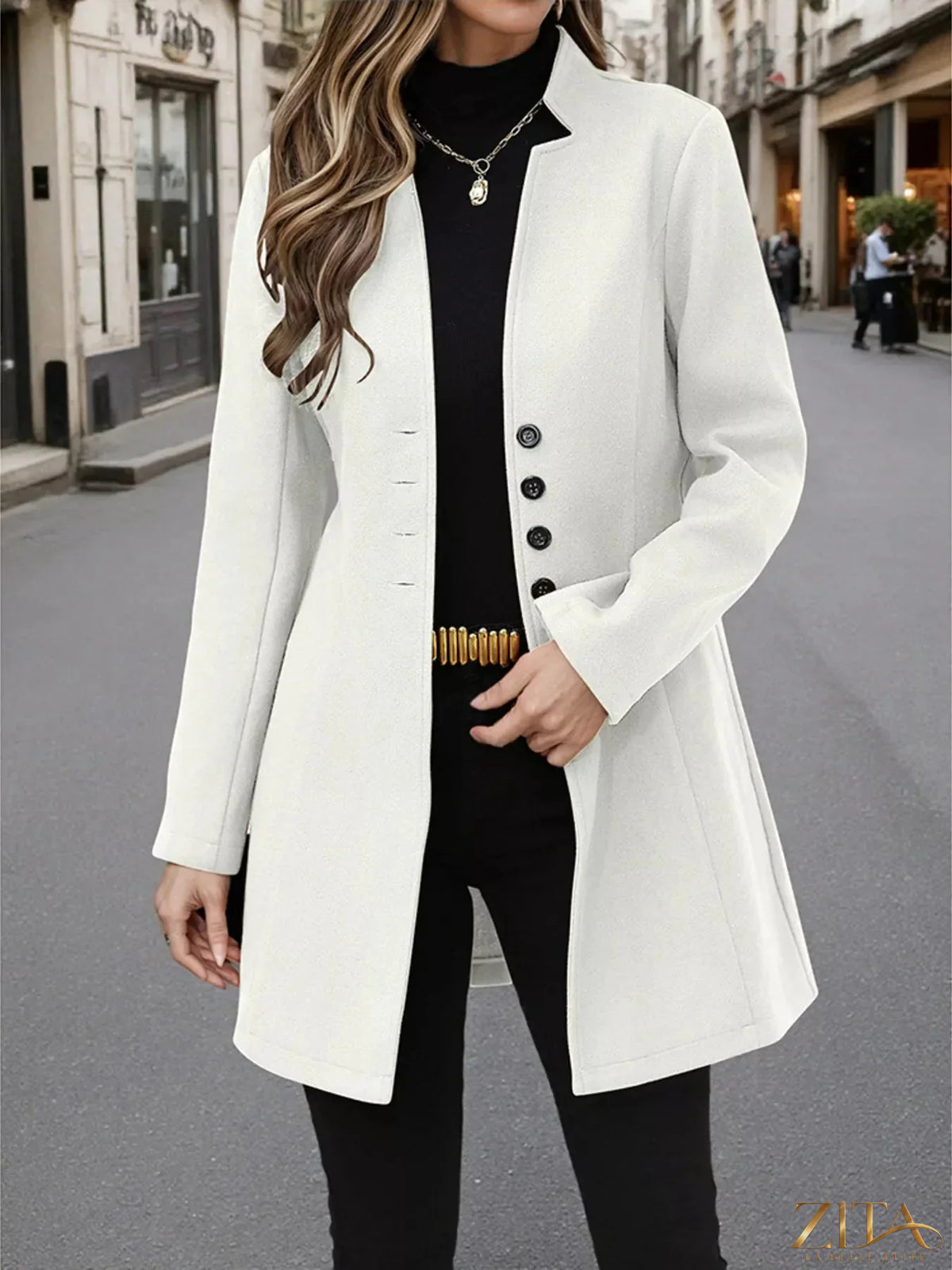 Zita La Belle Elite button-up long sleeve coat in neutral fabric, shown hanging on a wooden hanger.