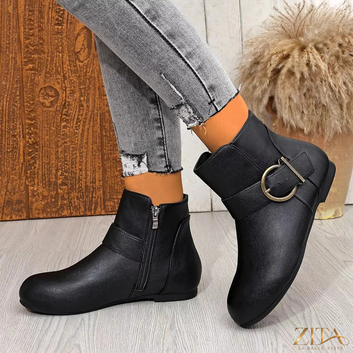Black round toe ankle boots by Trendsi with a sleek design and low block heel, perfect for stylish casual or office wear.