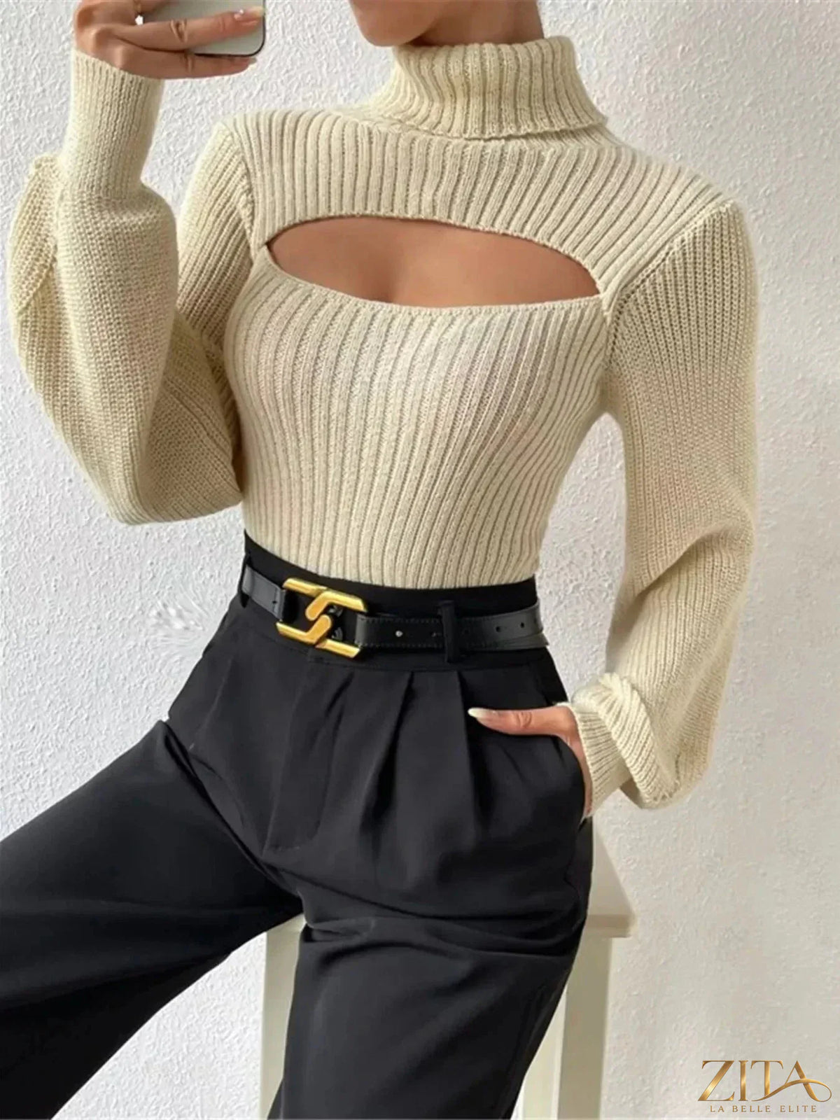 Black cutout front turtleneck long sleeve sweater by Trendsi, featuring a stylish design with a fitted silhouette and ribbed cuffs.