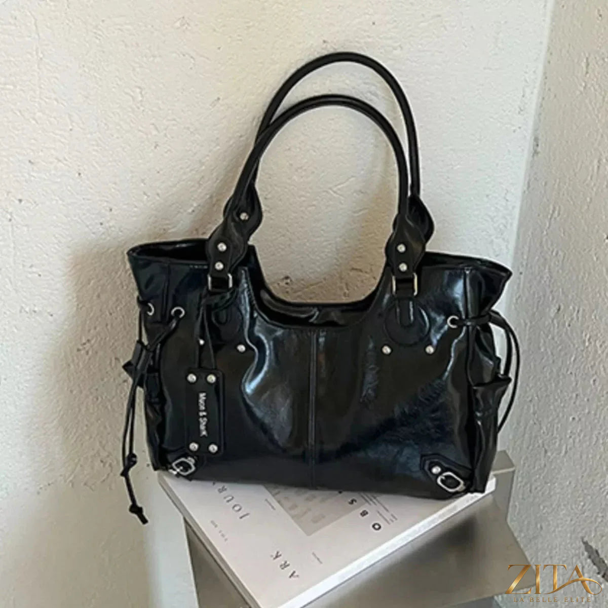 Drawstring leather handbag by Trendsi featuring a sleek design, adjustable strap, and stylish leather finish.