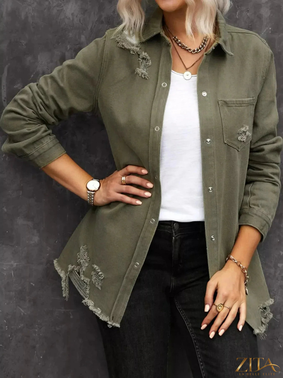 Zita La Belle Elite raw hem distressed denim shirt jacket with frayed edges and button closure, displayed on a hanger.