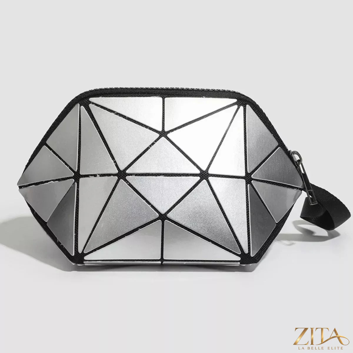 Geometric leather wristlet in neutral tones featuring a sleek design and a wrist strap, stylish accessory for everyday use.