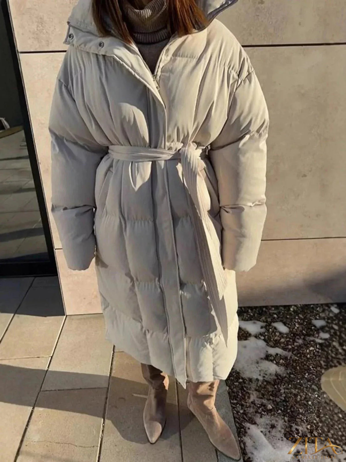 Longline padded winter coat with belt from Zita La Belle Elite, featuring a warm, quilted design and a stylish belt detail.
