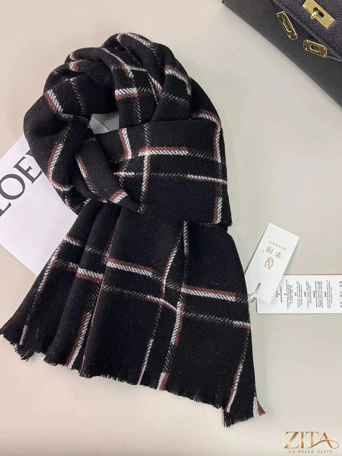 Zita La Belle Elite 100% wool plaid scarf with raw hem, featuring a classic tartan pattern in red, black, and white.
