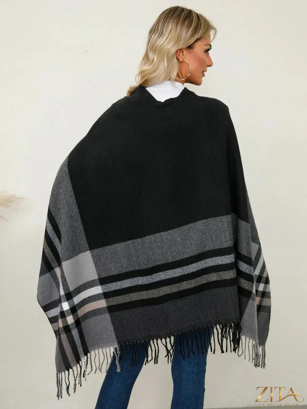 Trendsi fringe contrast plaid poncho with fringe trim and bold plaid pattern, perfect for casual fall or winter wear.