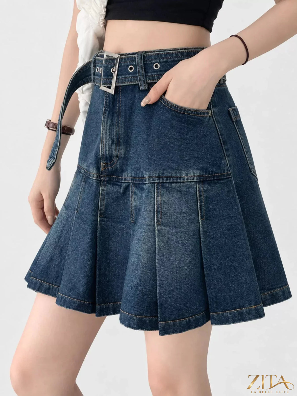 High-waisted pleated denim skirt from Trendsi, showcasing a stylish A-line cut and classic blue denim fabric.