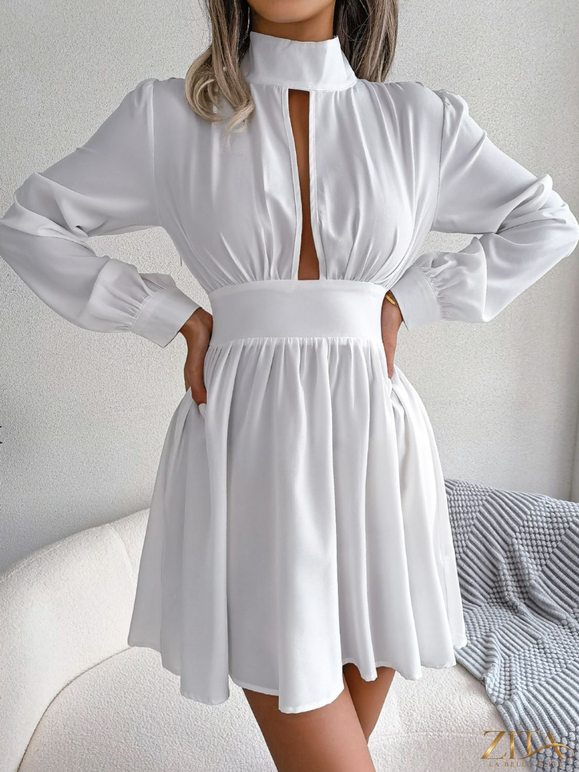 Black cutout turtleneck A-line mini dress from Trendsi, featuring a fitted silhouette and stylish design.