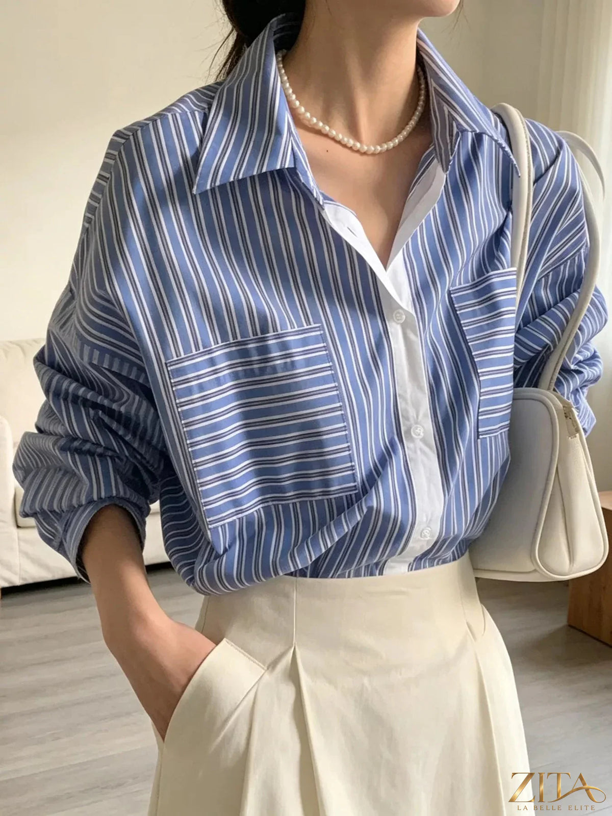 Zita La Belle Elite striped button-down shirt with blue, white, and red vertical stripes, displayed on a hanger.