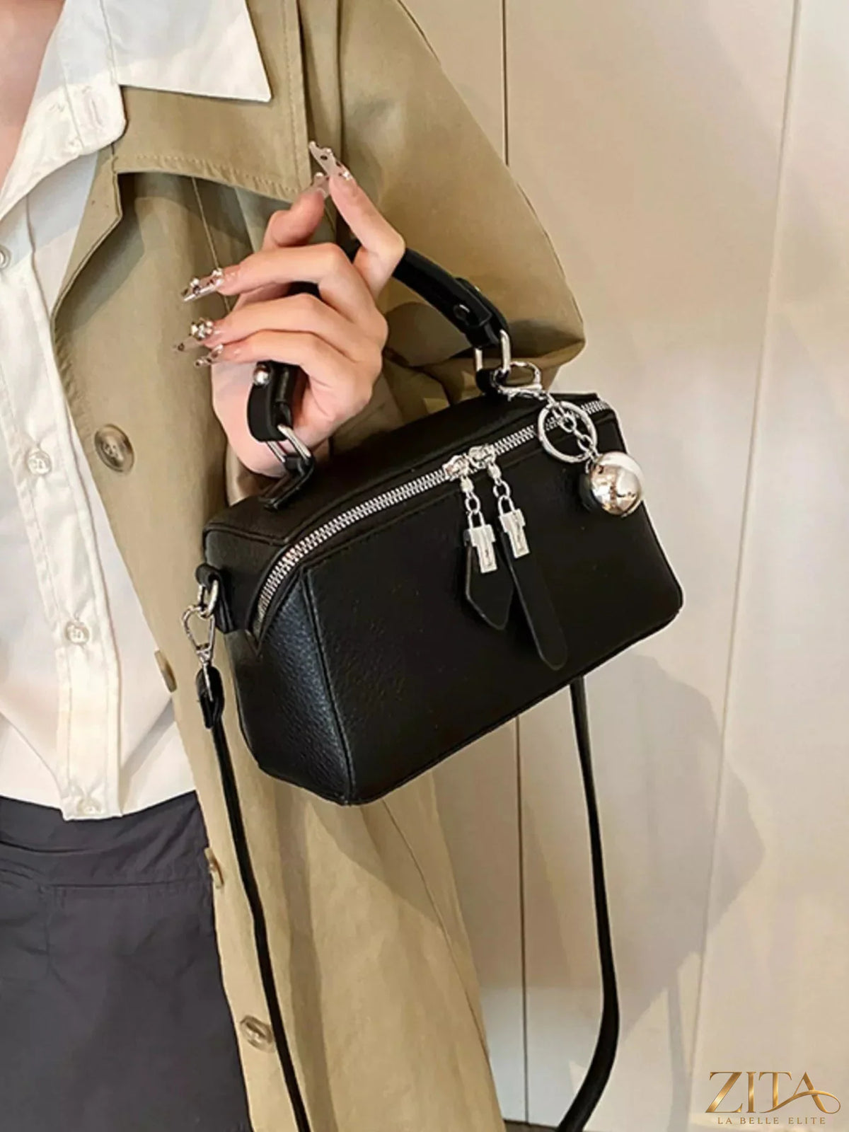 Textured leather handbag by Trendsi featuring a stylish design with top handle and subtle embossed details.