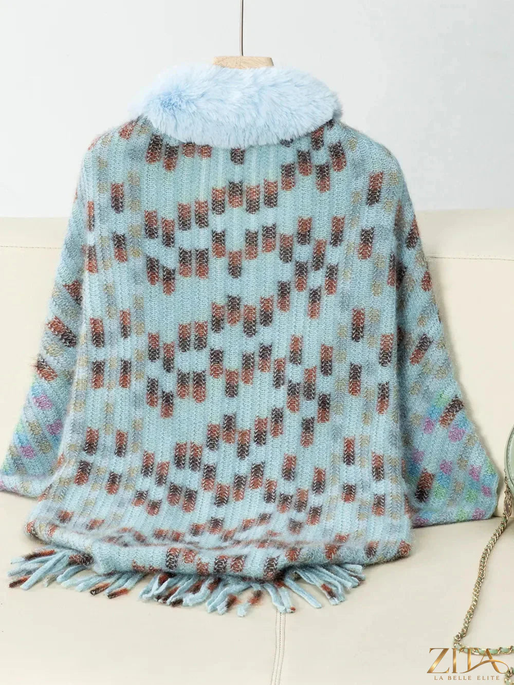Fuzzy open front fringed poncho in neutral tones, stylish and cozy, perfect for layered fall or winter outfits.