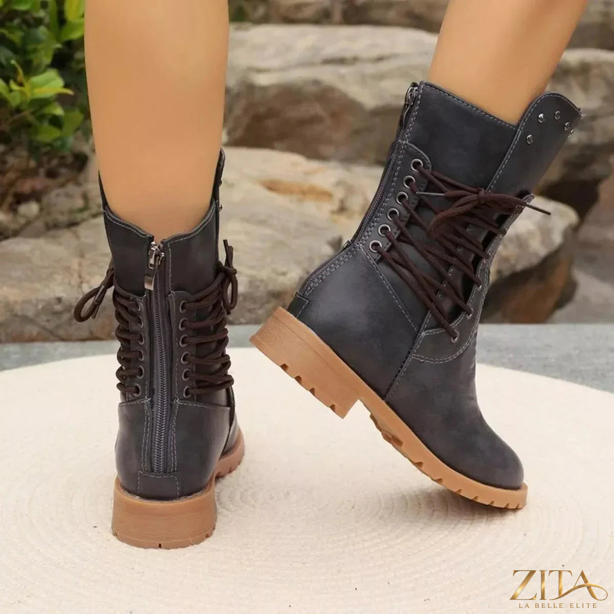 Black studded lace-up boots by Trendsi featuring metal studs and durable leather upper with chunky sole.