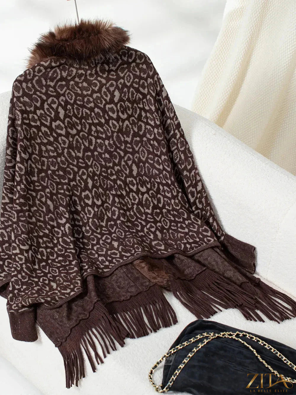 Leopard print fringe open front long sleeve poncho from Trendsi, featuring a stylish animal pattern and flowing design.