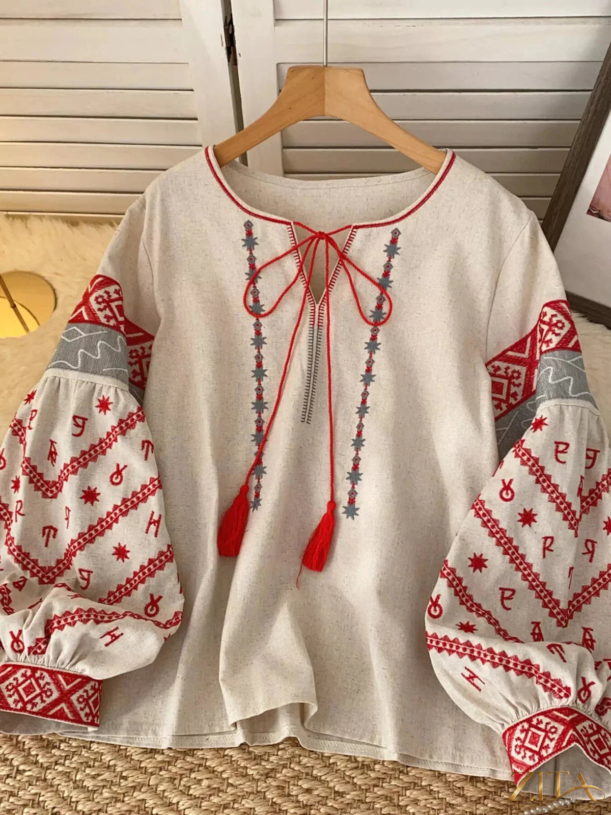 Zita La Belle Elite embroidered tie-neck blouse featuring intricate embroidery, long sleeves, and a stylish collar.