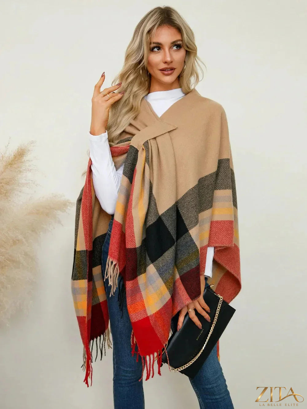 Fringe contrast plaid poncho from Trendsi featuring a cozy, stylish design with fringed edges and a classic plaid pattern.
