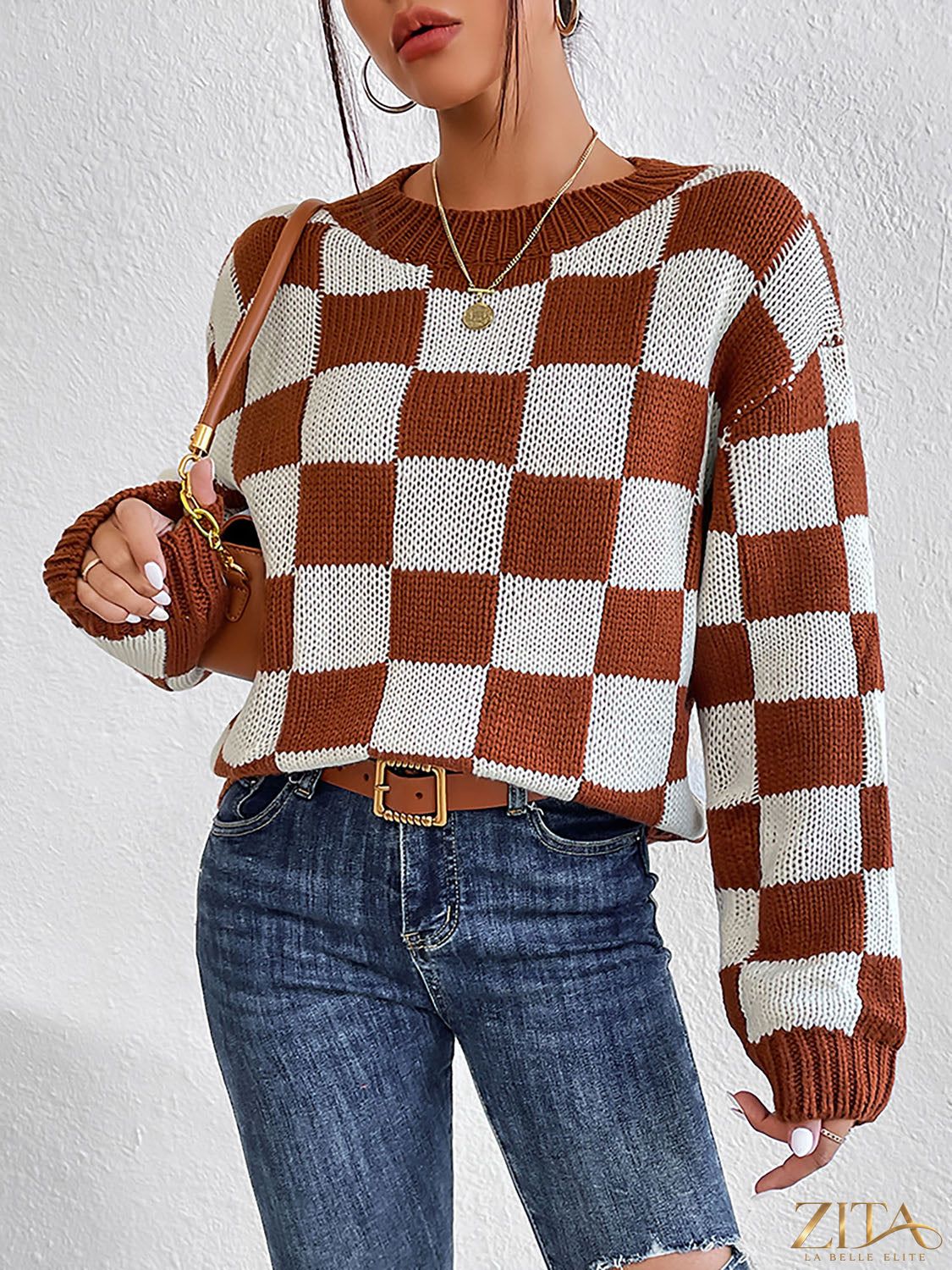 Checkered round neck sweater by Trendsi featuring a stylish black and white checkered pattern, long sleeves, and comfortable fit.