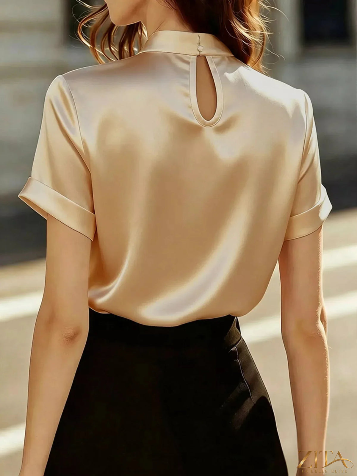 Pearl-embellished satin blouse by Zita La Belle Elite, featuring elegant design and smooth fabric, shown on a white background.