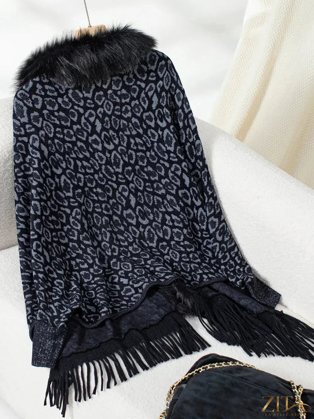 Leopard print fringe open front long sleeve poncho by Trendsi, featuring a stylish design with fringed edges and long sleeves.