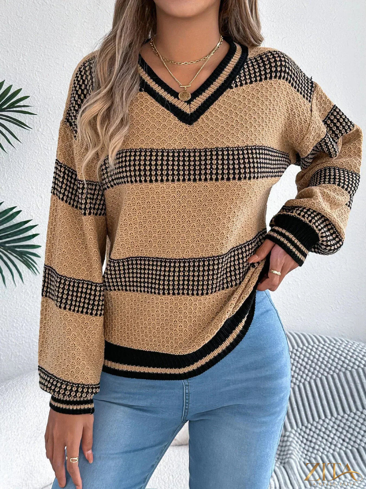 Contrast striped V-neck sweater from Trendsi featuring bold color blocks and a relaxed fit, displayed on a mannequin.