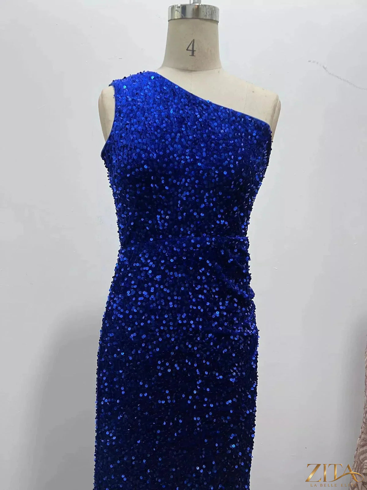 Zita La Belle Elite one-shoulder ruched sequin high-slit evening dress displayed on a model in a stylish setting.