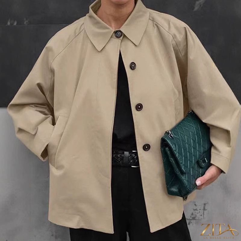 Women’s French-style loose mid-length trench coat by Zita La Belle Elite, shown in beige with classic lapels and belt details.