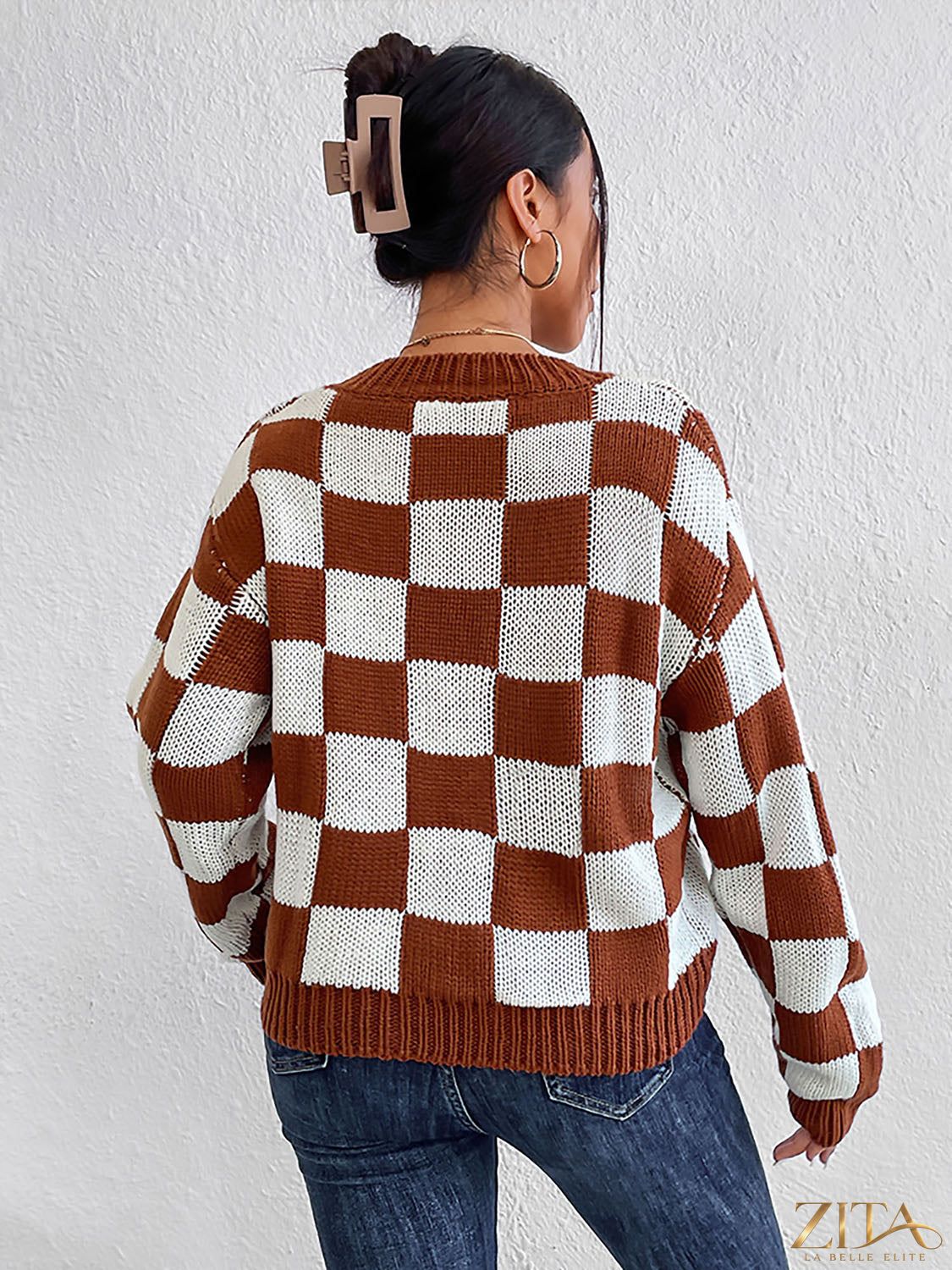 Checkered round neck sweater by Trendsi featuring a stylish black and white checkered pattern and a comfortable fit.