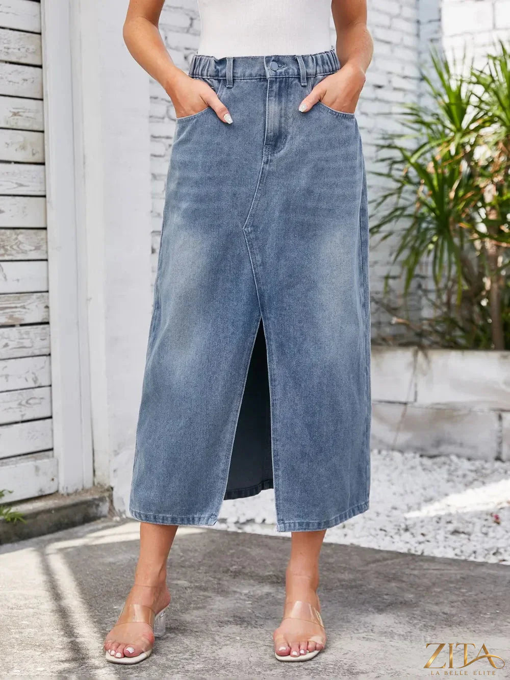 Zita La Belle Elite slit midi denim skirt with pockets, featuring a stylish design and a leg slit, displayed on a model.