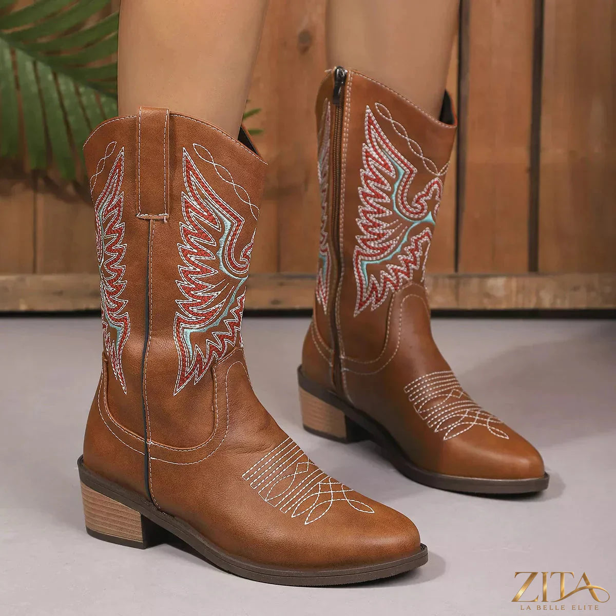 Embroidered Western cowboy boots with intricate floral embroidery and classic leather design, by Trendsi.