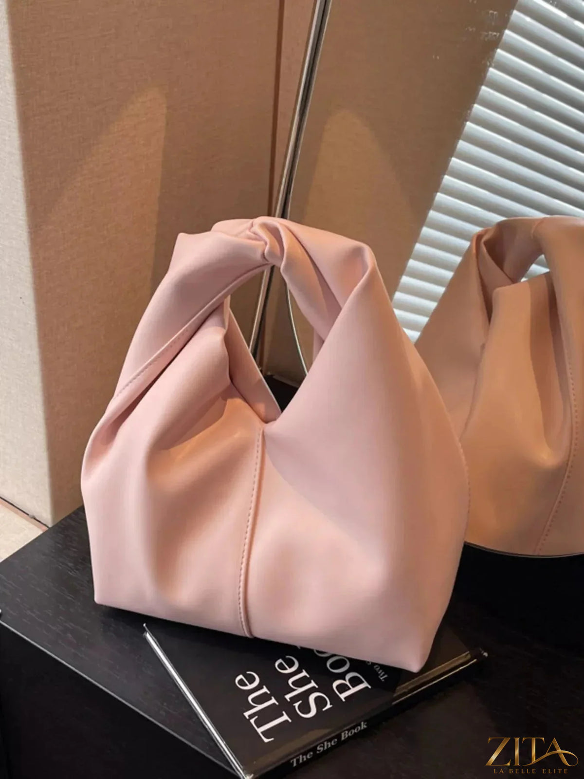 Zita La Belle Elite knot handle leather handbag with top zipper closure and stylish design, featuring a smooth leather finish.