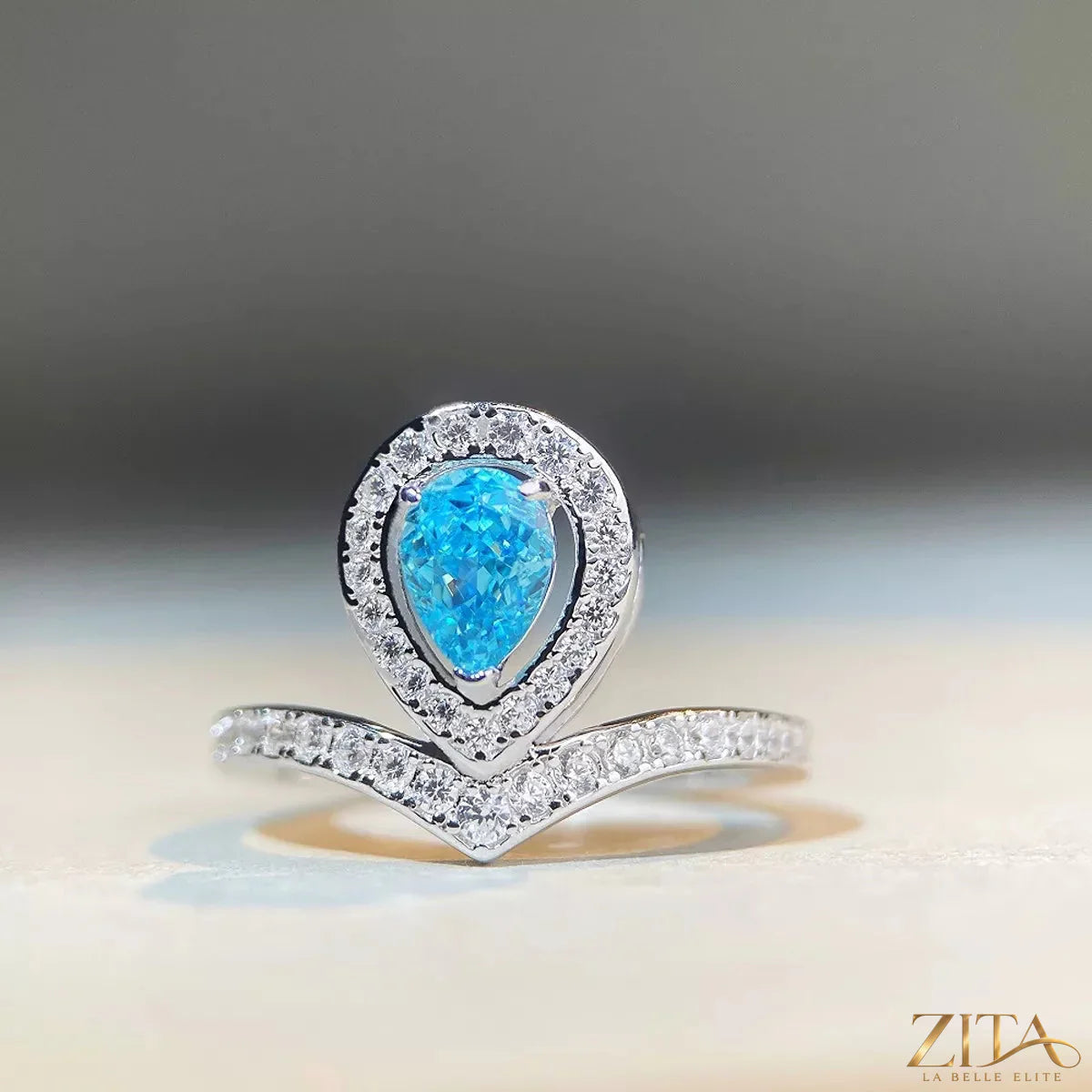Sterling silver zircon teardrop ring with a sleek design, featuring a shiny gemstone centerpiece and delicate band.