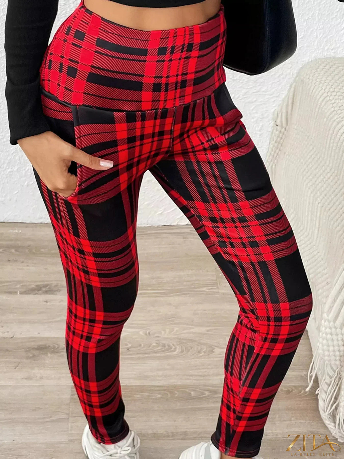 High-waisted plaid slim-fit leggings from Trendsi showing their stretchy fabric and stylish checked pattern.
