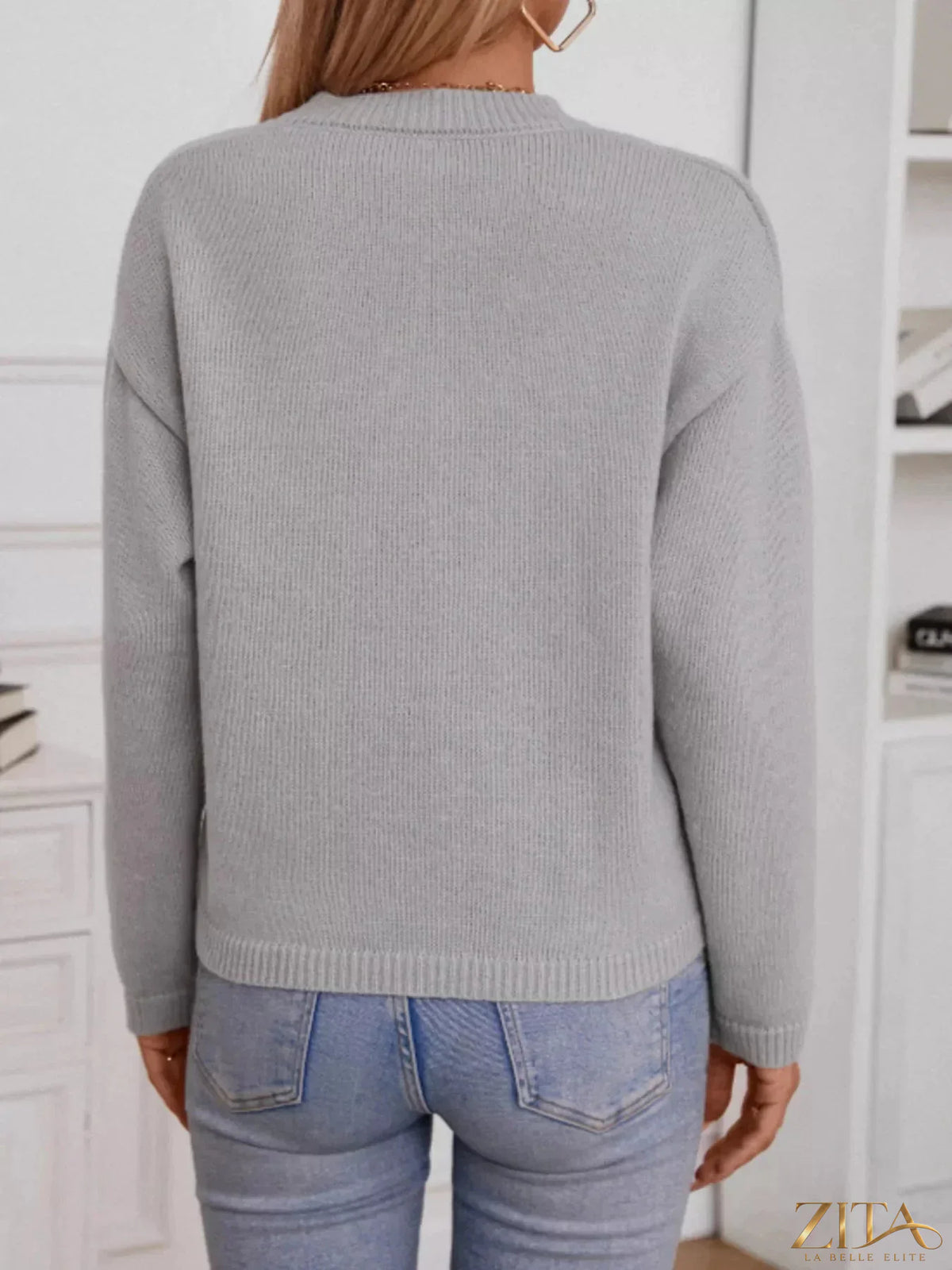 Notched dropped shoulder sweater in neutral color, featuring relaxed fit and ribbed cuffs, by Trendsi.