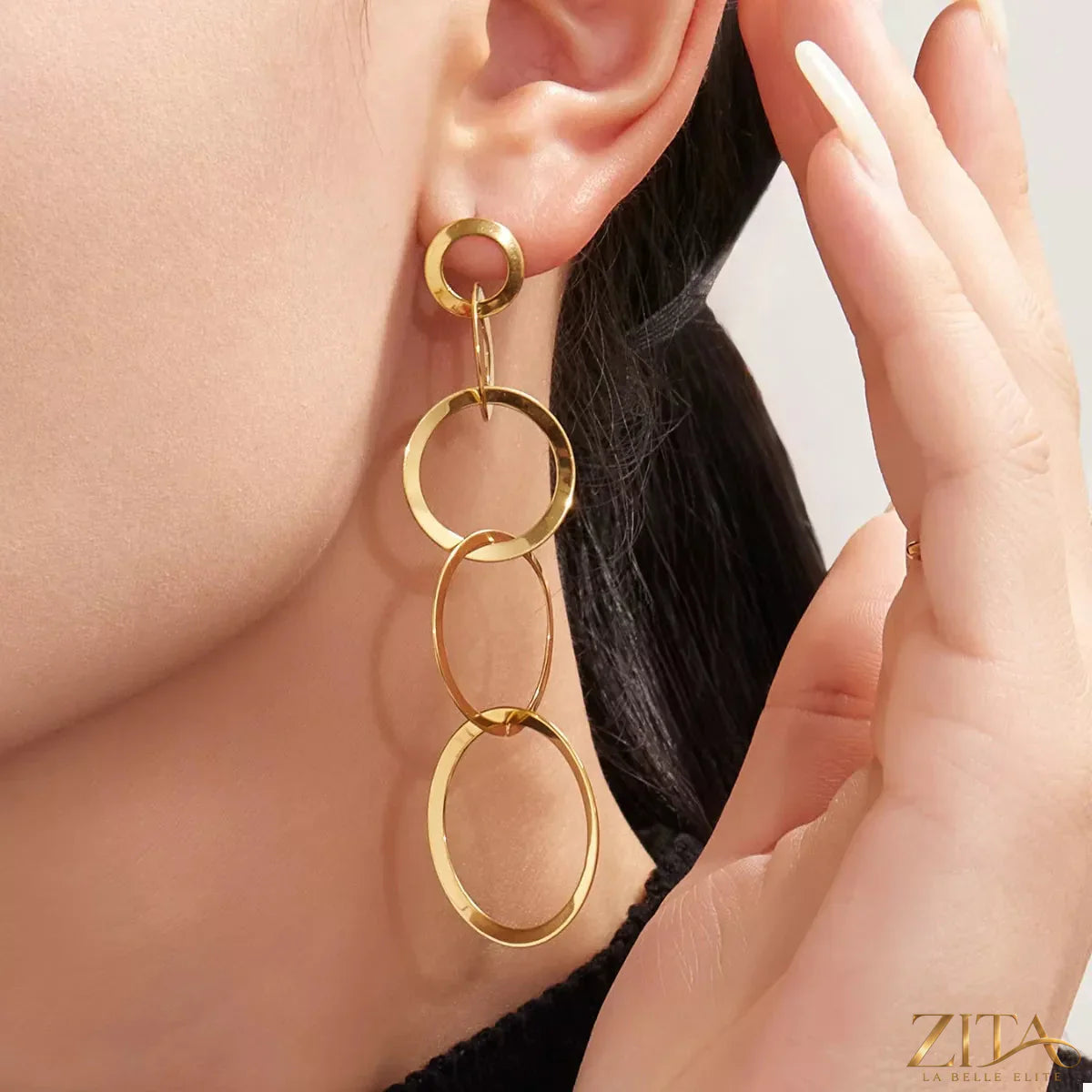 Round 18K gold-plated titanium steel earrings by Zita La Belle Elite, showcasing sleek, polished jewelry with a shiny finish.