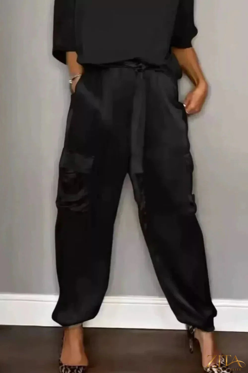 Satin round neck top and matching pants set by Trendsi, featuring a smooth, shiny fabric and a relaxed fit.