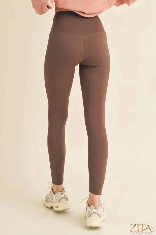 Yelete fleece-lined high-waisted leggings in black, showcasing their cozy, full-size fit and stretchy fleece interior.