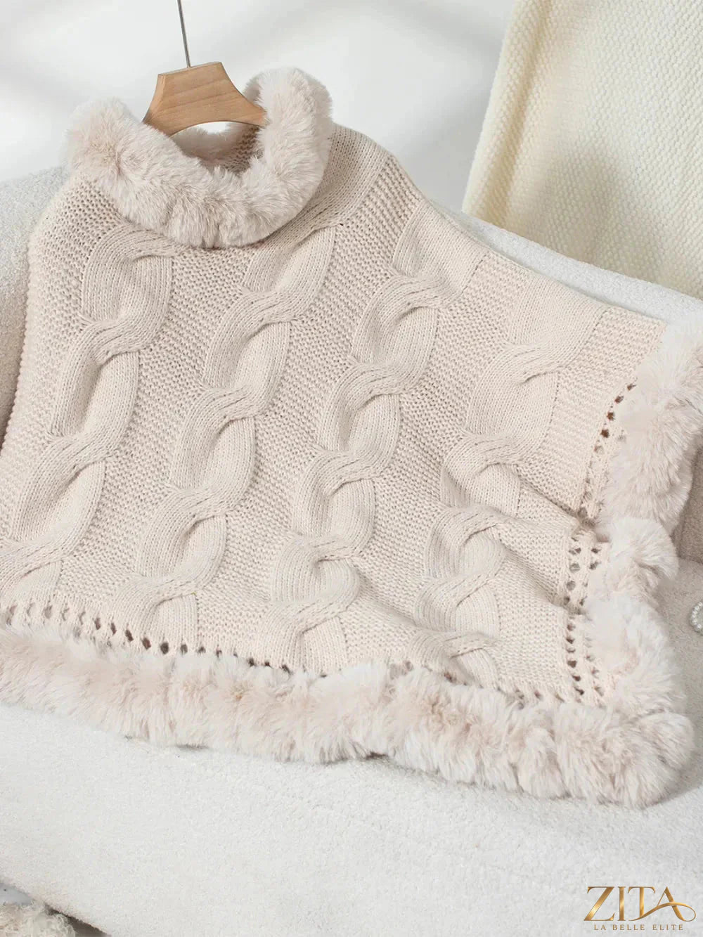 Fuzzy hem cable-knit poncho by Trendsi featuring a cozy, textured design and relaxed fit, perfect for stylish layering.