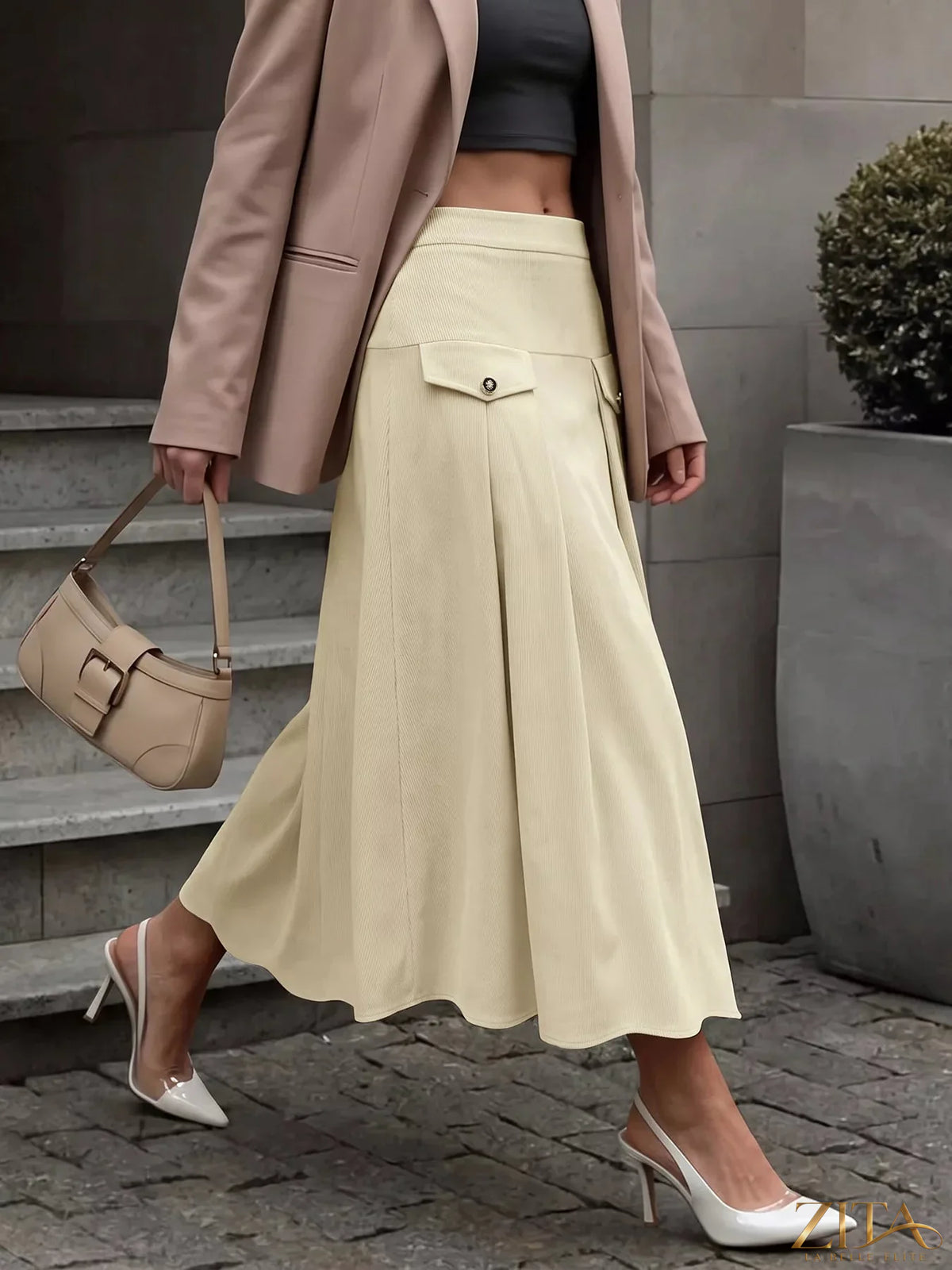 Zita La Belle Elite high waist pleated midi skirt in a flowing fabric, shown with a focus on the pleated design and elegant length.